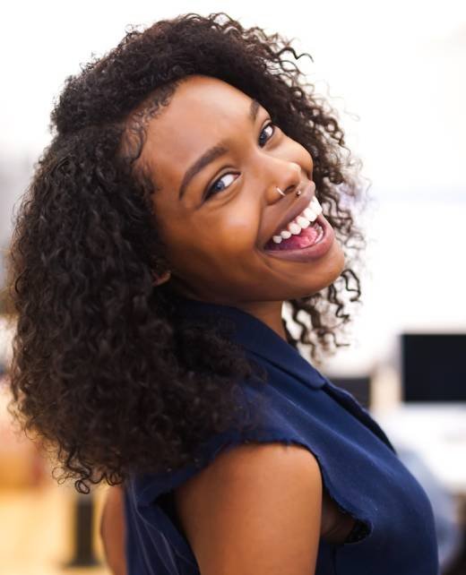 woman looking back while smiling